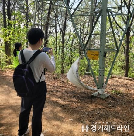 수원특례시 관계자가 국가지점번호판을 조사하고 있다.